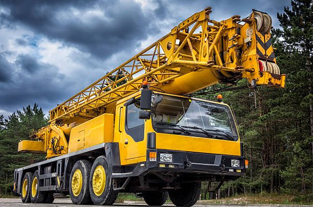Yellow mobile crane in road construction